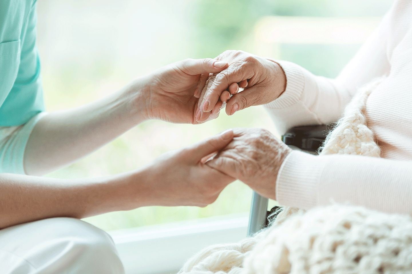 Caregiver holding hands with a client