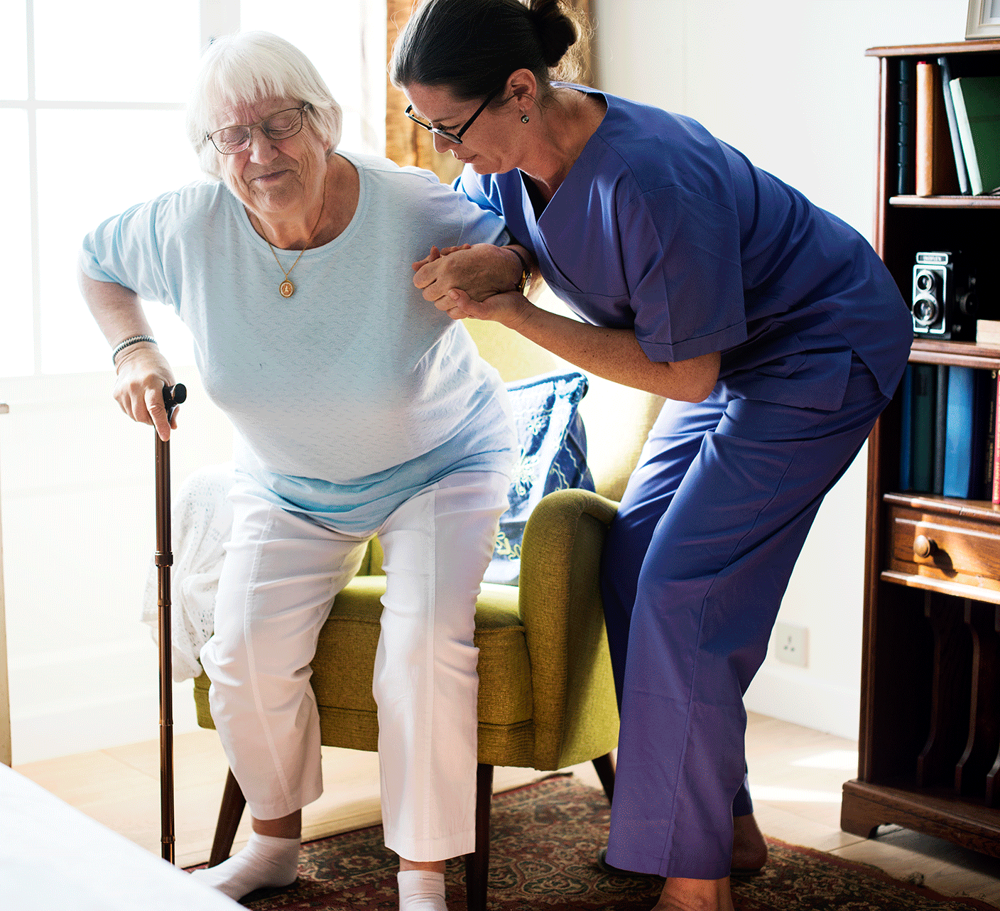 Nurse helping a senior woman stand